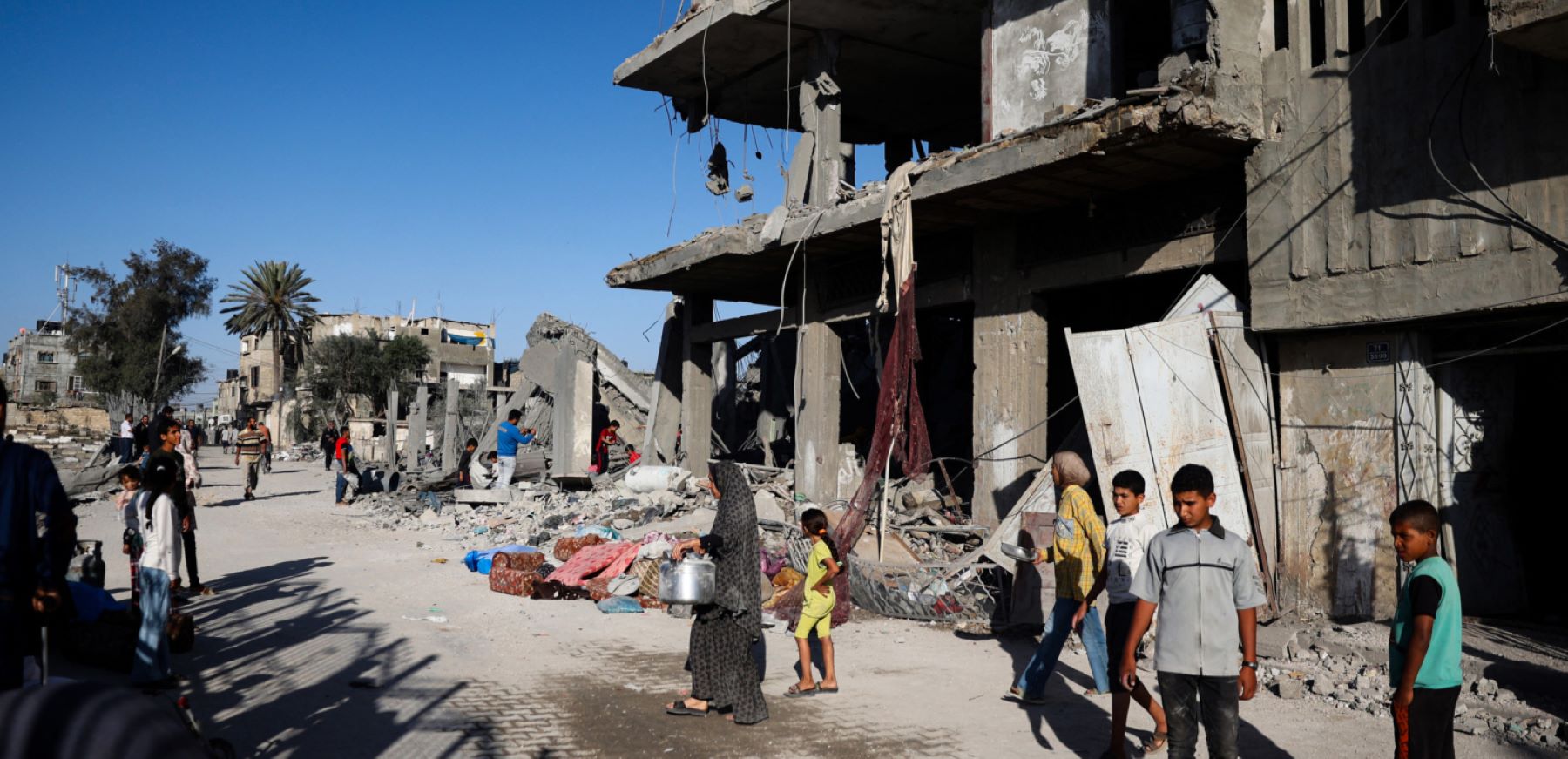 Palestinians salvage belongings from the rubble of a building hit by overnight Israeli bombing in Rafah in the southern Gaza Strip on April 20, 2024, amid the ongoing conflict between Israel and the Hamas movement. Photo by -/AFP via Getty Images.