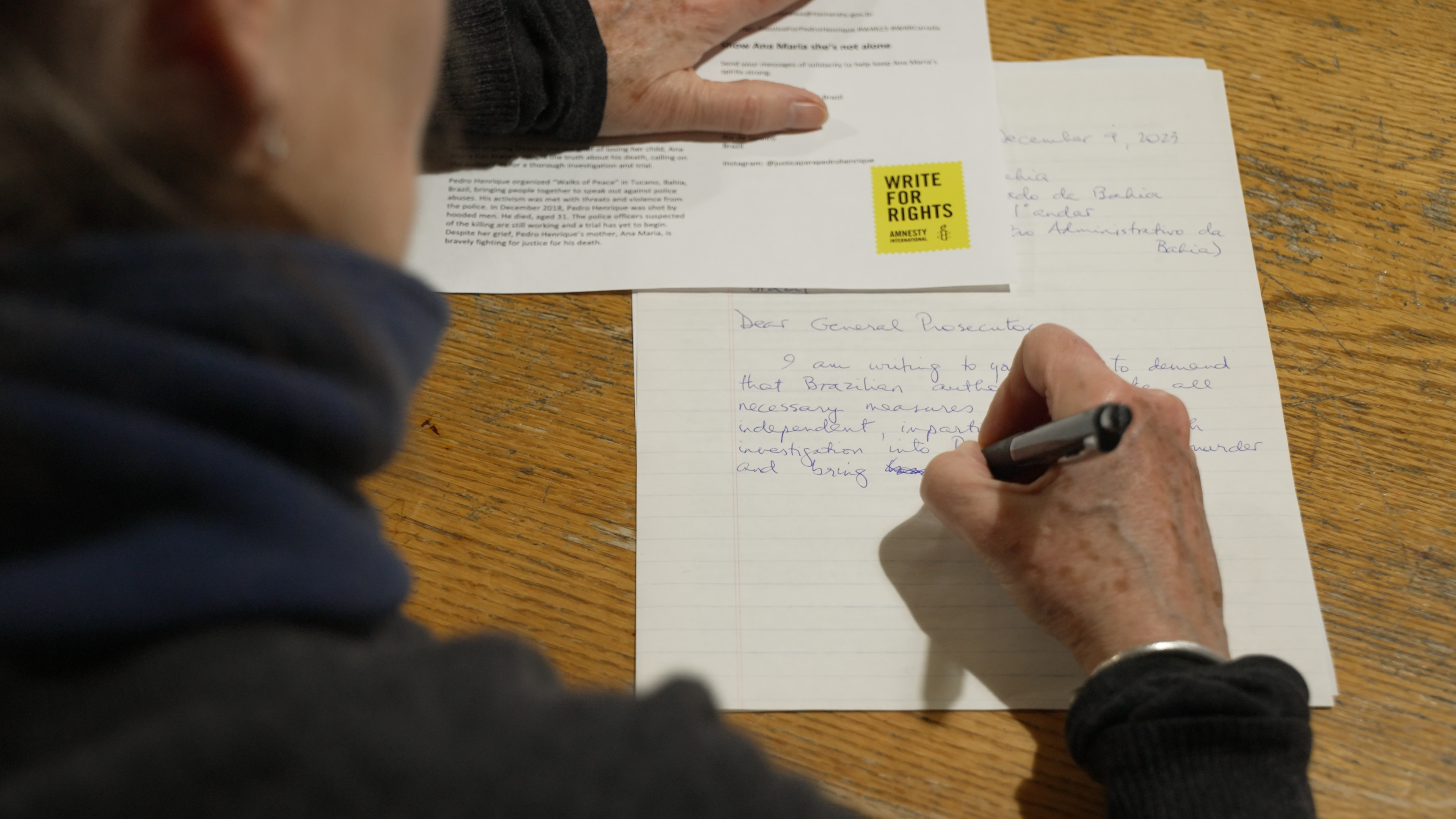 A volunteer writing a letter at the Write for Rights event in Canada
