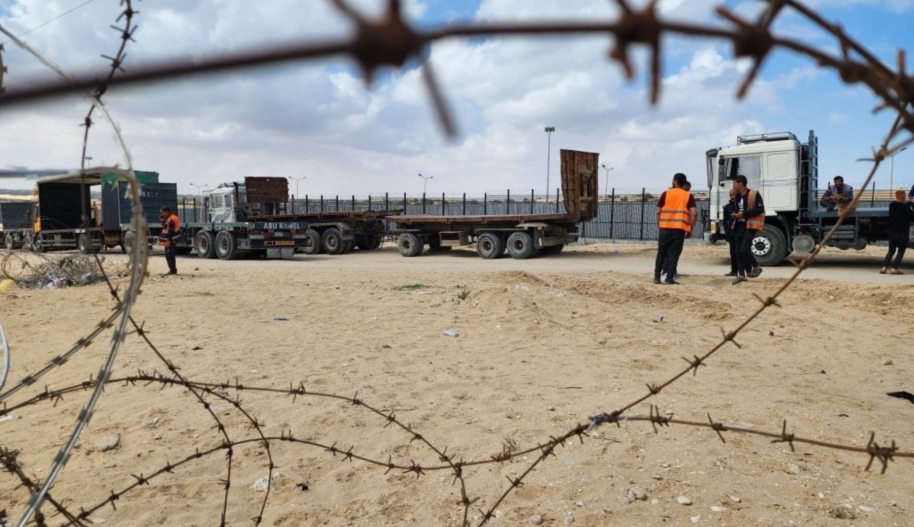 Palestinian truck drivers and United Nations vehicles wait near the Rafah border gate on the Gazan side on May 14, 2024. Photo by Hani Alshaer/Anadolu via Getty Images.