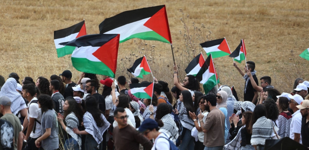Arab-Israeli protestors march with Palestinian national flags during a rally near Israel's northern city of Shefa Amr, on May 14, 2024, ahead of the Palestinian marking of the 76th anniversary of the Nakba ©AHMAD GHARABLI/AFP via Getty Images.