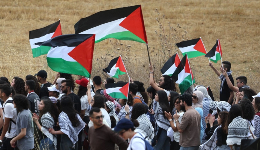 Arab-Israeli protestors march with Palestinian national flags during a rally near Israel's northern city of Shefa Amr, on May 14, 2024, ahead of the Palestinian marking of the 76th anniversary of the Nakba ©AHMAD GHARABLI/AFP via Getty Images.