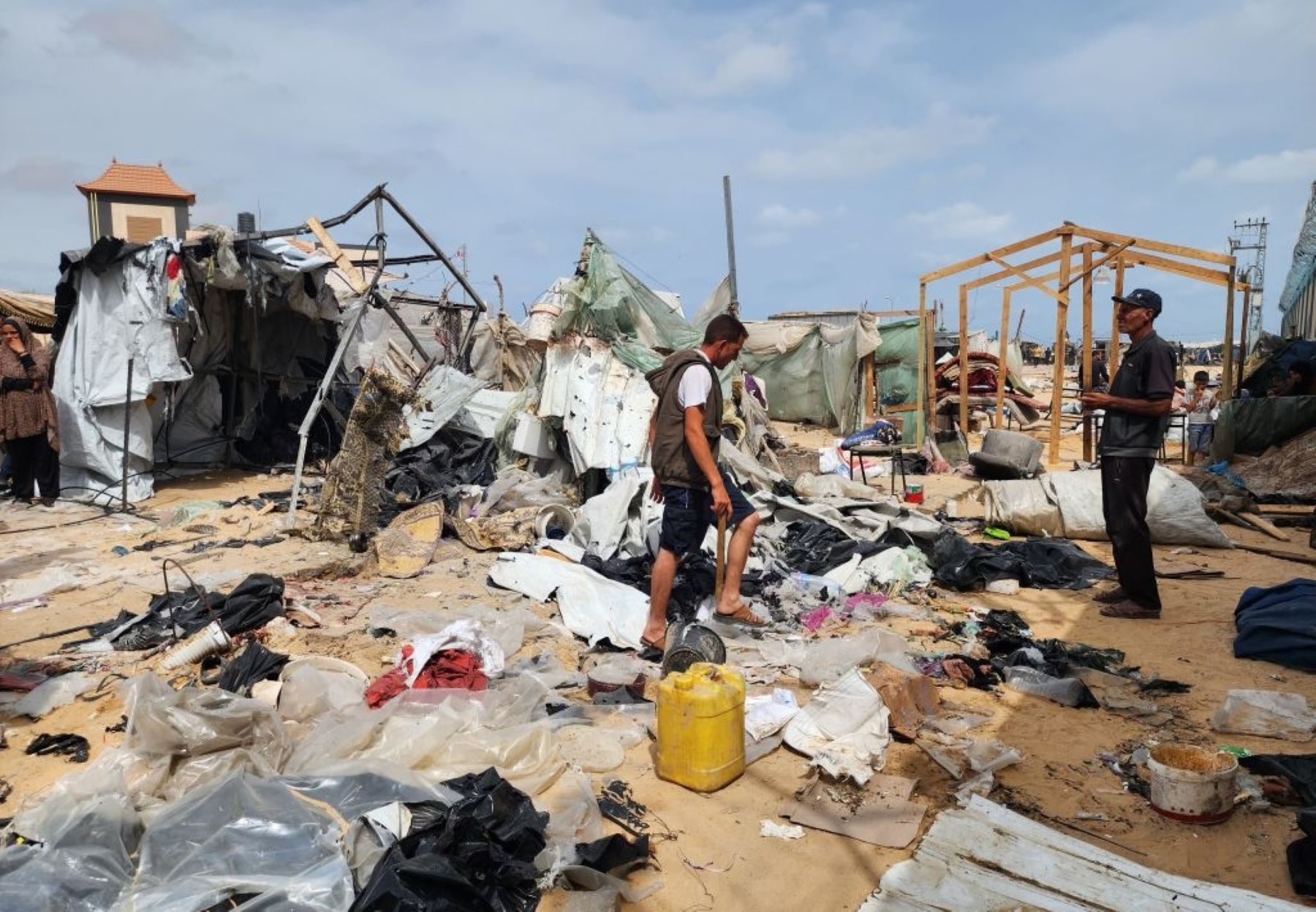 Palestinians examine the destroyed makeshift tents and collect usable items after Israeli army attacks on tents of displaced Palestinians living near the United Nations Relief and Works Agency for Palestine Refugees (UNRWA) warehouses in Rafah, Gaza on May 28, 2024. Photo by Hani Alshaer/Anadolu via Getty Images.