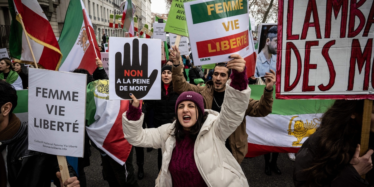 A protestor holds a slogan against the death penalty during a rally in Lyon on January 8, 2023 against the Iranian regime,