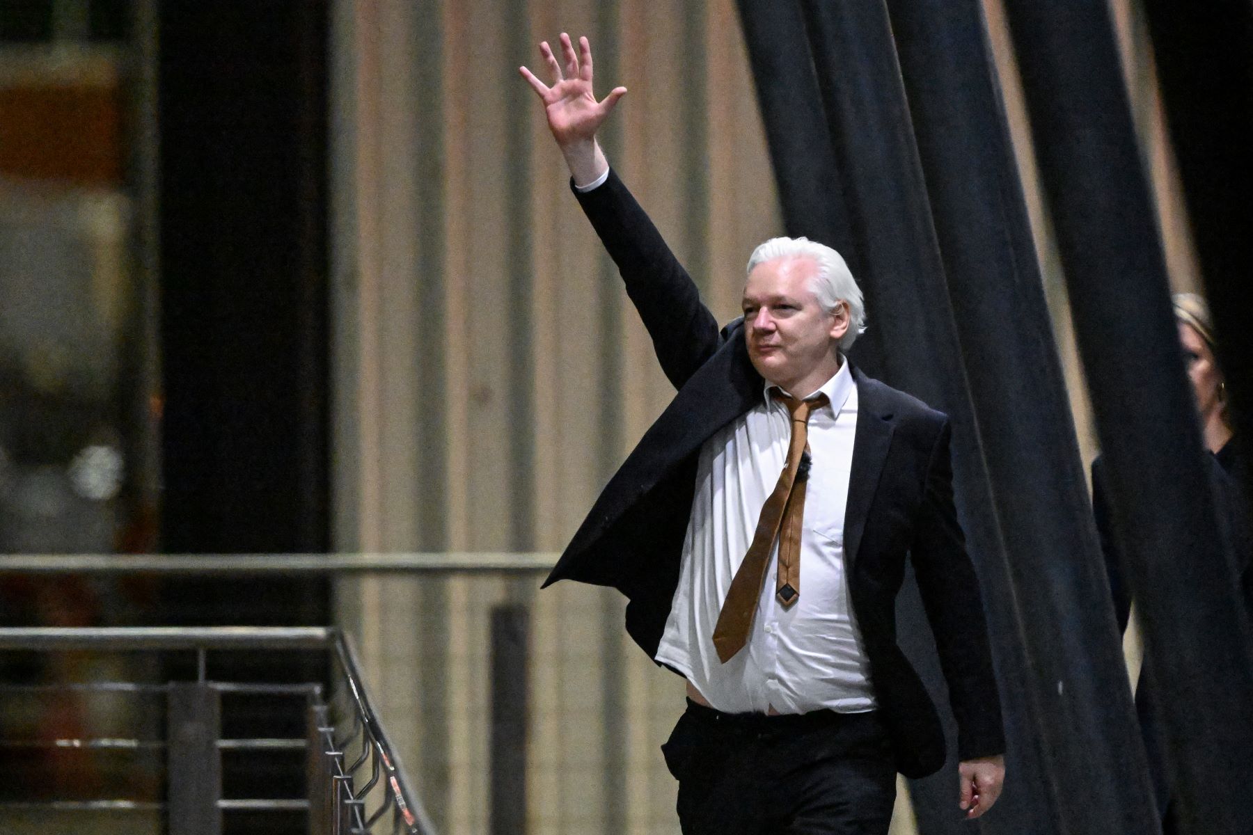 WikiLeaks founder Julian Assange waves after arriving at Canberra Airport in Canberra on June 26, 2024. Photo by WILLIAM WEST / AFP) (Photo by WILLIAM WEST/AFP via Getty Images.