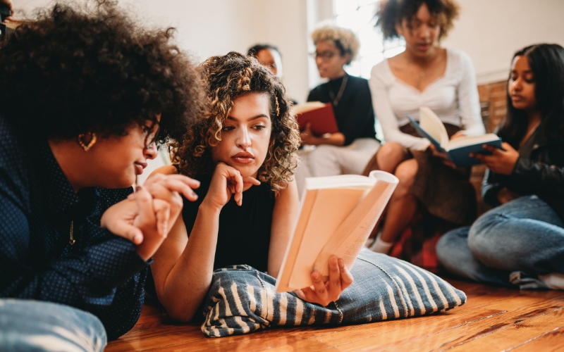 Group of young women meet to read and discuss books from the Amnesty Book Club 2024 selections