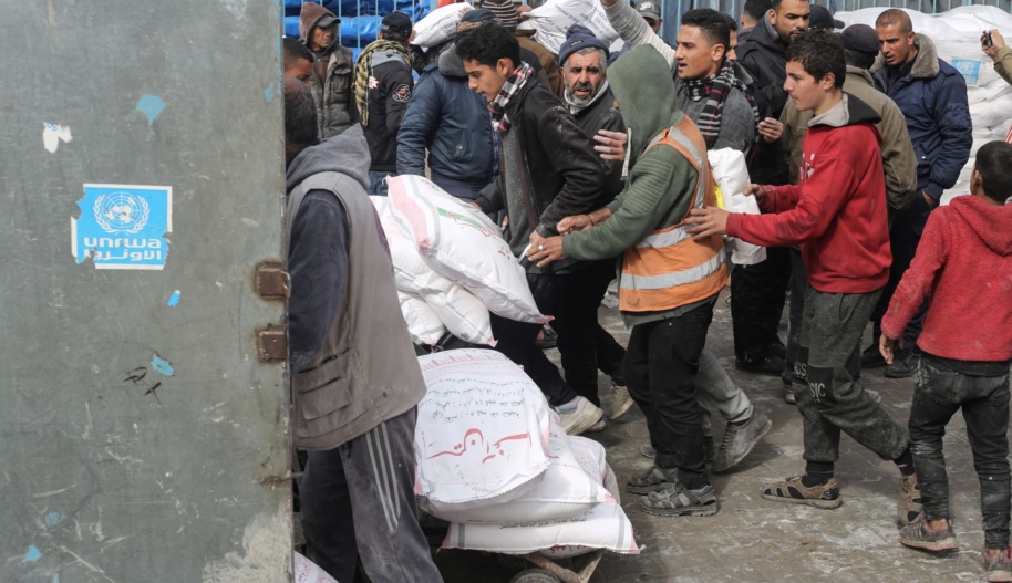 The United Nations Relief and Works Agency for Palestine Refugees UNRWA) distributes flour to families as Israeli attacks continue in Rafah of Gaza on January 28, 2024. Photo by Ahmed Zaqout/Anadolu via Getty Images.