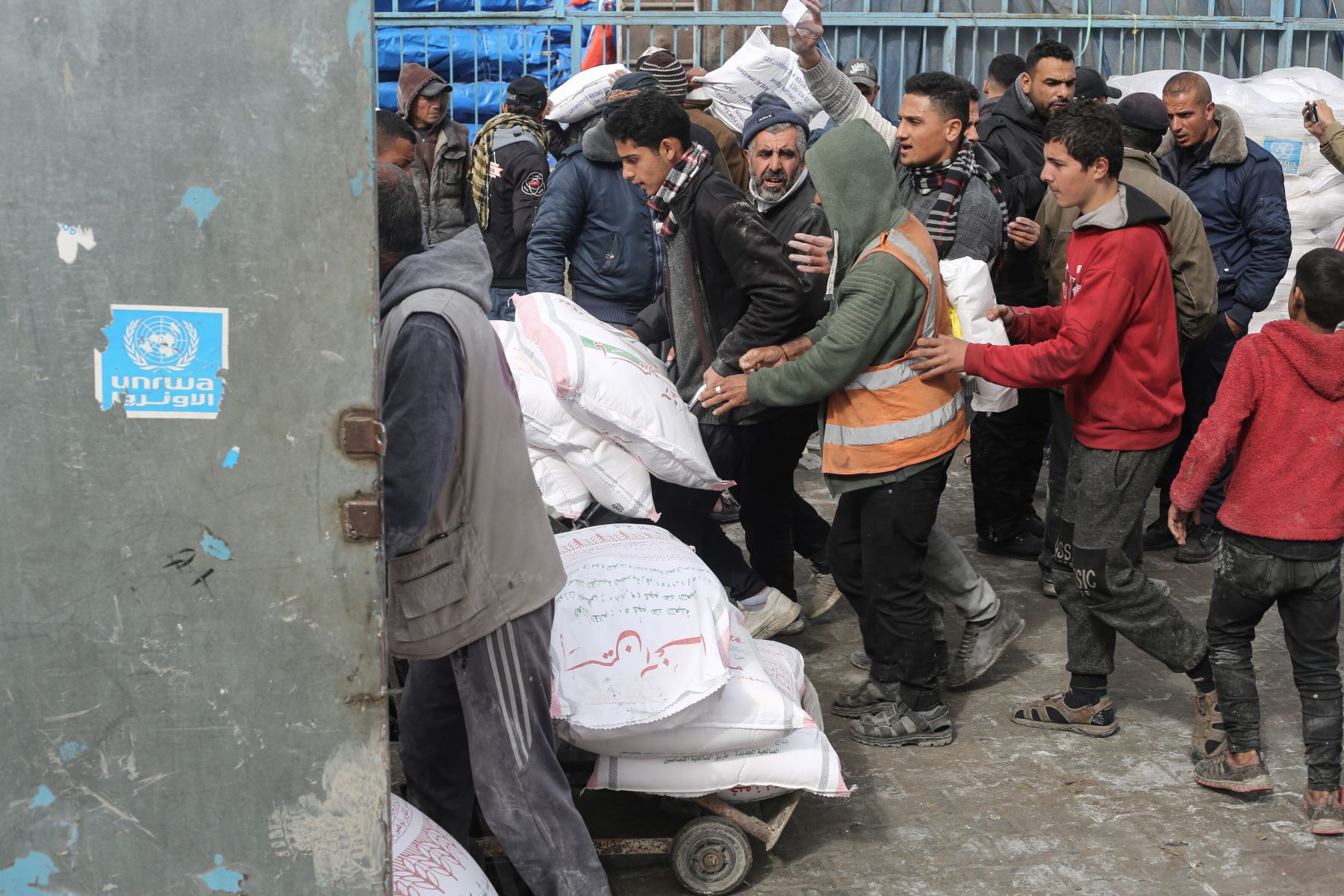 The United Nations Relief and Works Agency for Palestine Refugees UNRWA) distributes flour to families as Israeli attacks continue in Rafah of Gaza on January 28, 2024. Photo by Ahmed Zaqout/Anadolu via Getty Images.