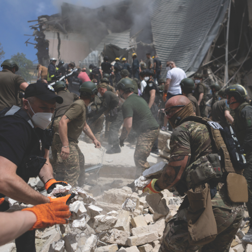 People clear rubble at a Kyiv children's hospital