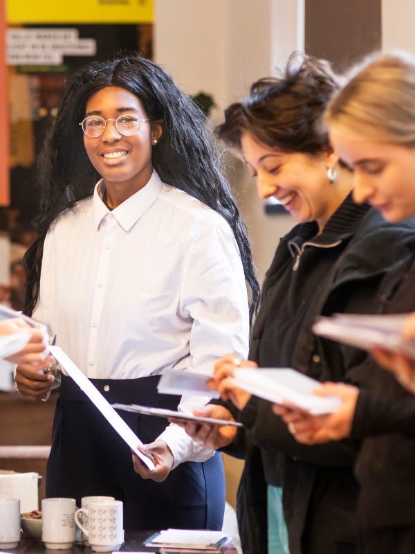 Young women from AI Netherlands counting letters for Write for Rights 2023.