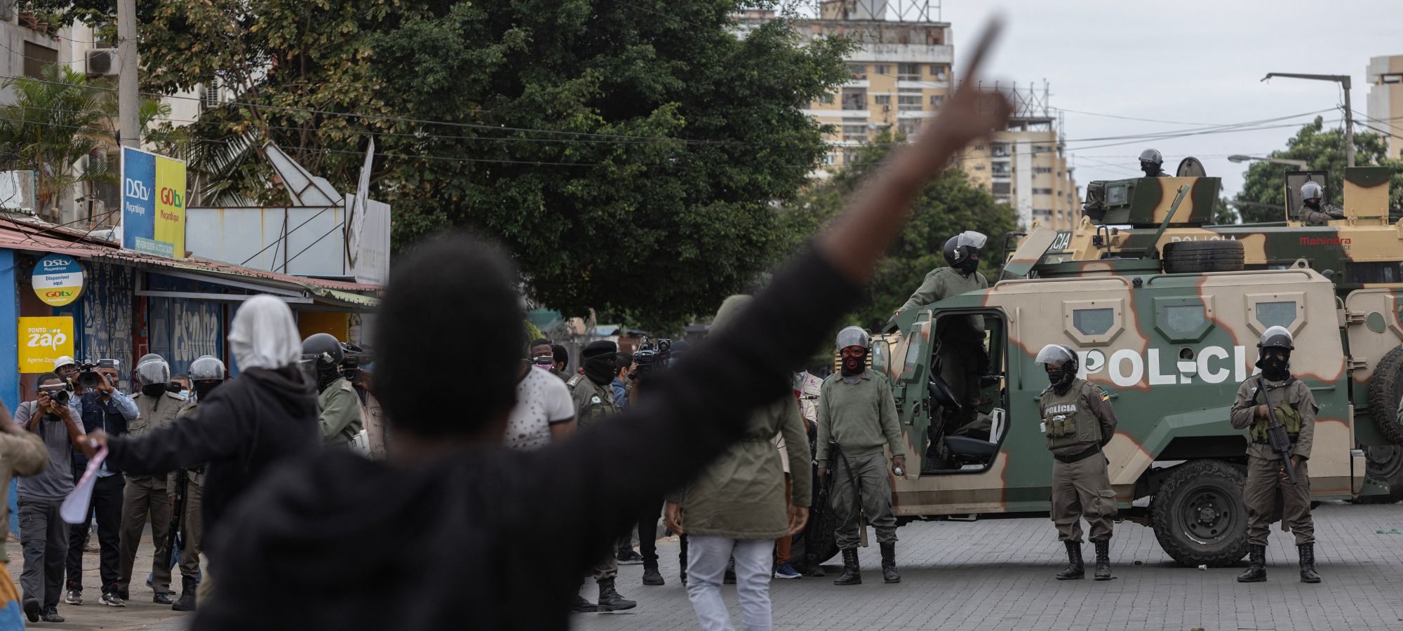 Protesters look on as Mozambique riot police officers block the road in Maputo, on November 7, 2024. (Photo by ALFREDO ZUNIGA/AFP via Getty Images)