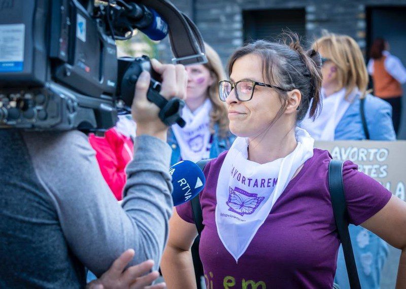 Women standing in front of the camera in protest at a rally