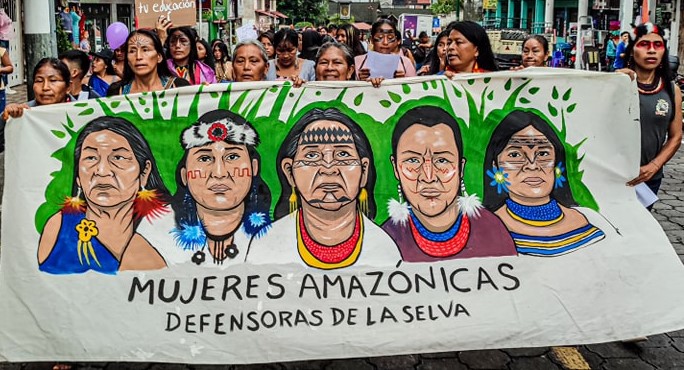 Indigenous women take to the streets carrying a banner