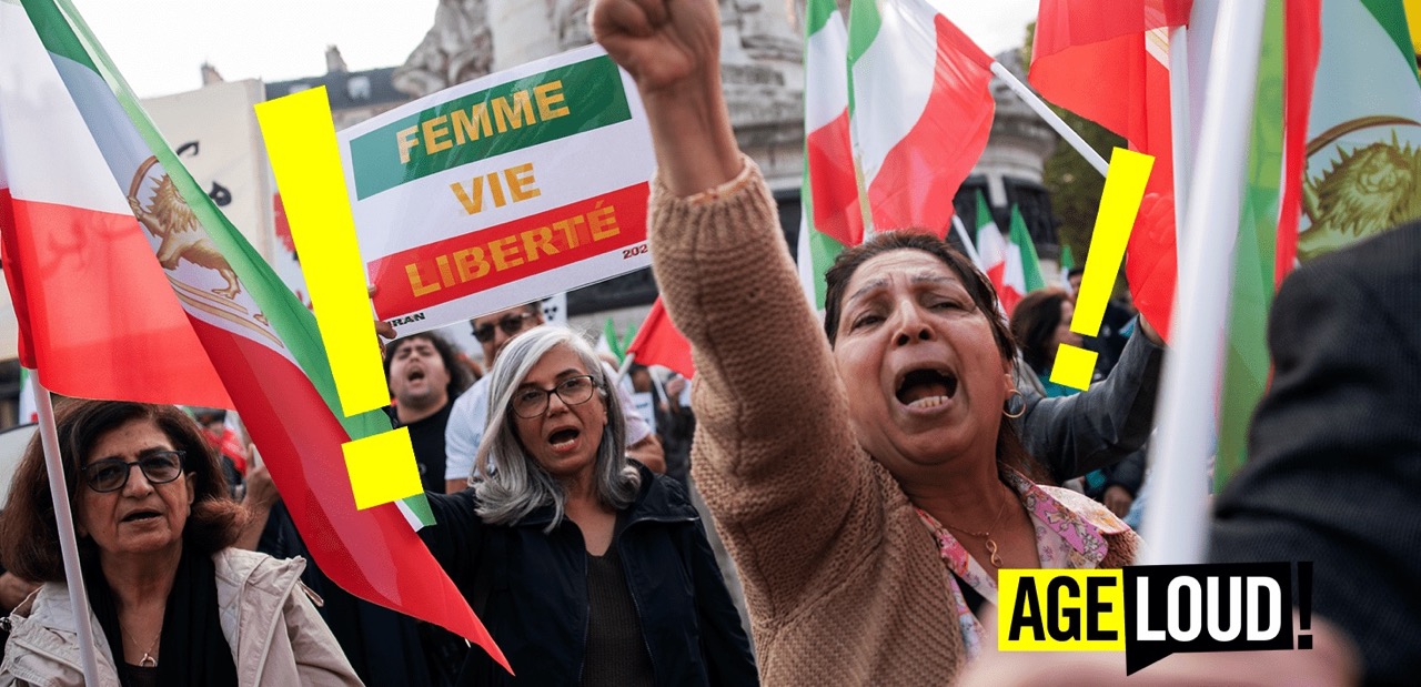 Women yelling during a protest with flags and signs