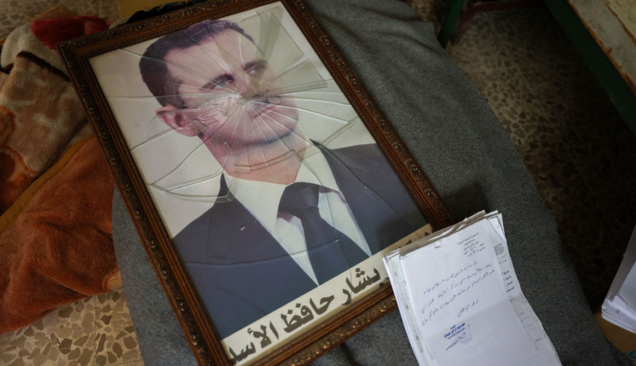 Framed photograph of Bashar Al-Assad with the glass cracked