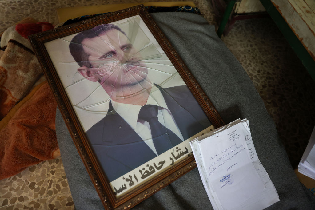 Framed photograph of Bashar Al-Assad with the glass cracked