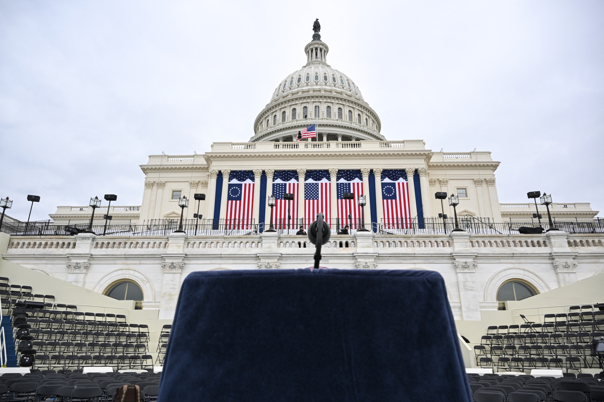 A lectern and microphone stands on a platform stage on the West Front of the US Capitol building, where the presidential inauguration traditionally takes place,