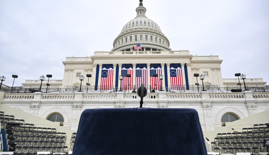 A lectern and microphone stands on a platform stage on the West Front of the US Capitol building, where the presidential inauguration traditionally takes place,