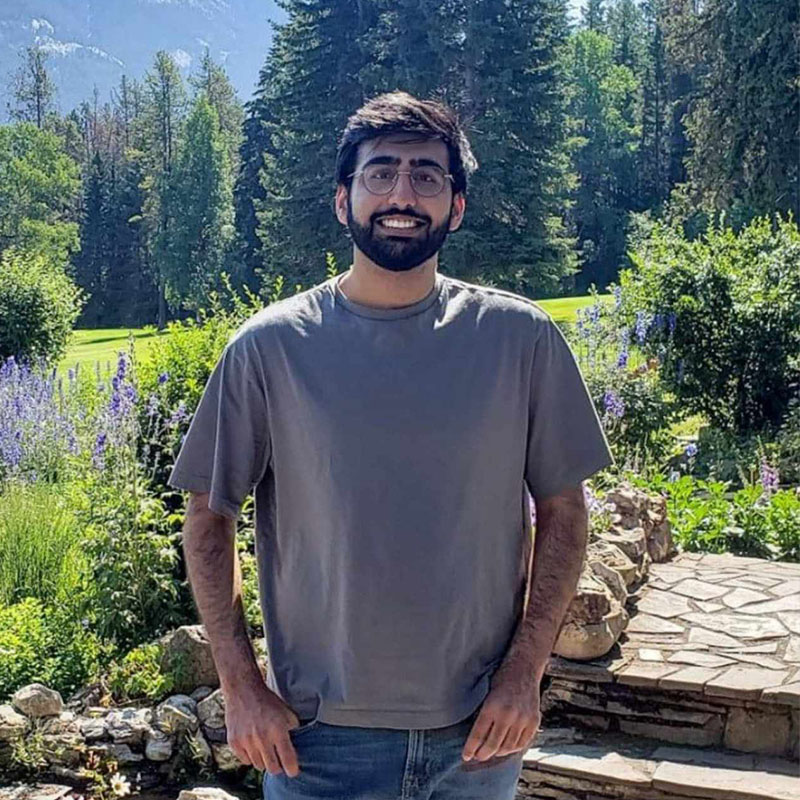 Young man smiling in front of national park