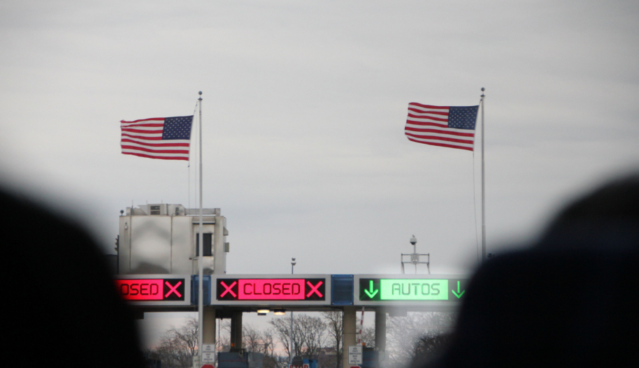 American flags fly over electric signs at the Canada.-U.S. border