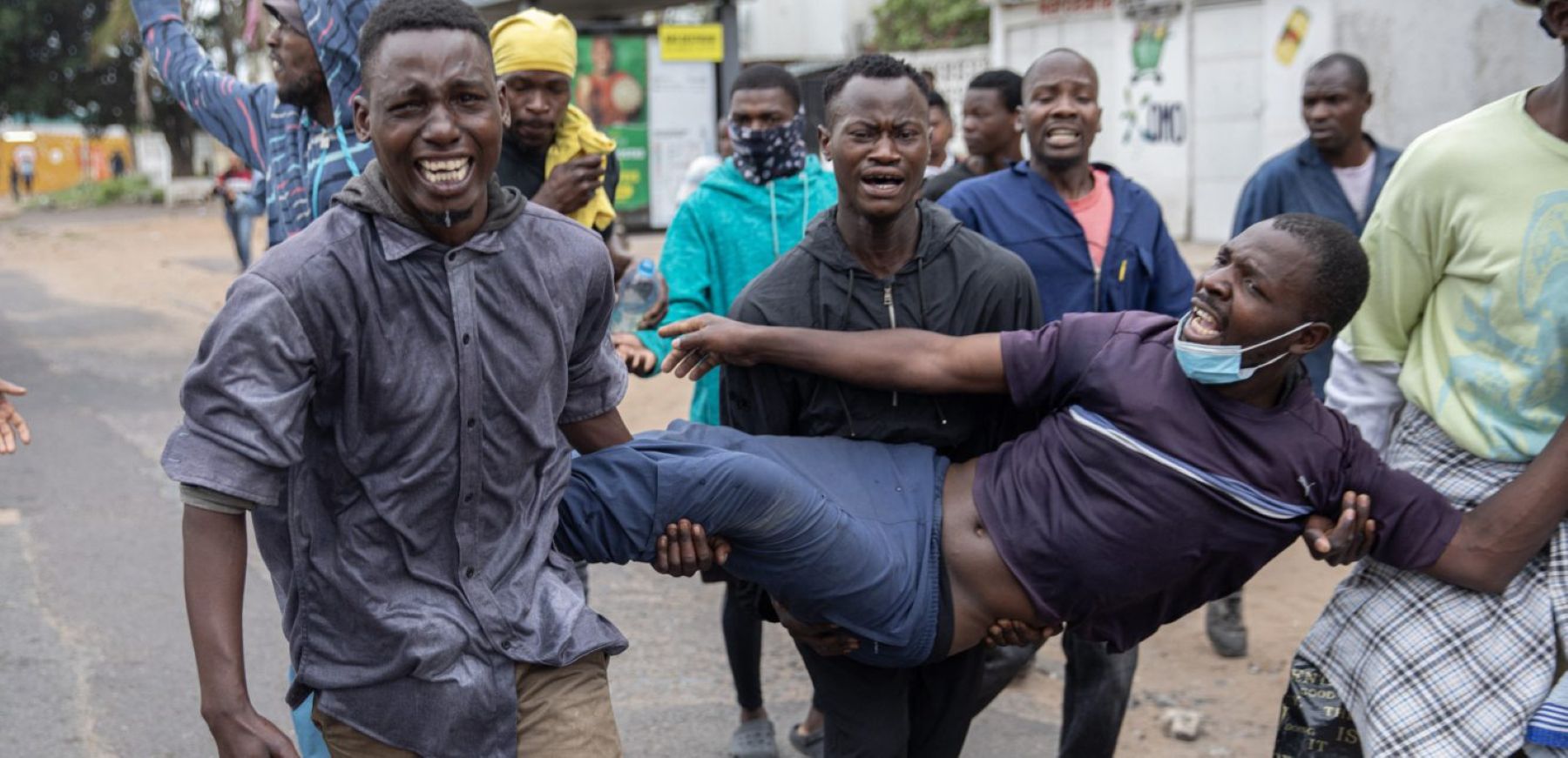 Protesters carry a protester injured by a rubber bullet fired by riot police in Maputo, on November 7, 2024. Photo by ALFREDO ZUNIGA/AFP via Getty Images.