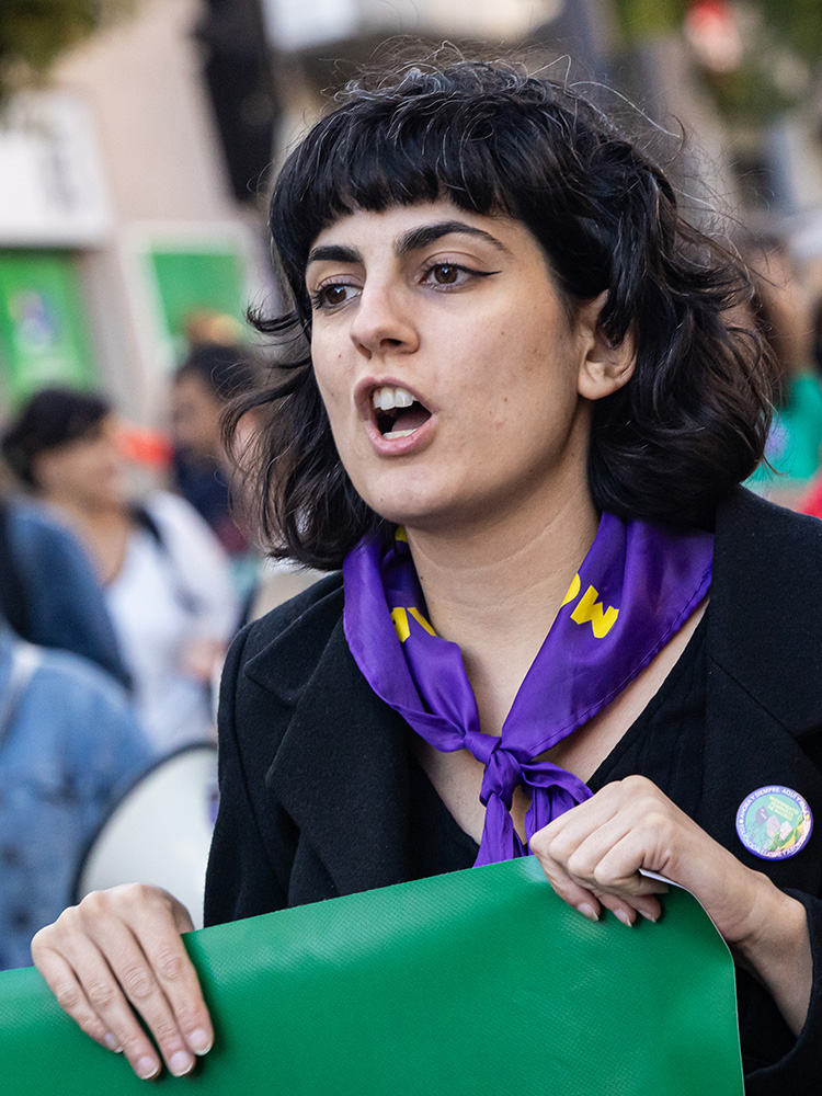 A woman wearing a purple handkerchief shouts during an abortion rights protest on September 28, 2024 in Madrid, Spain.