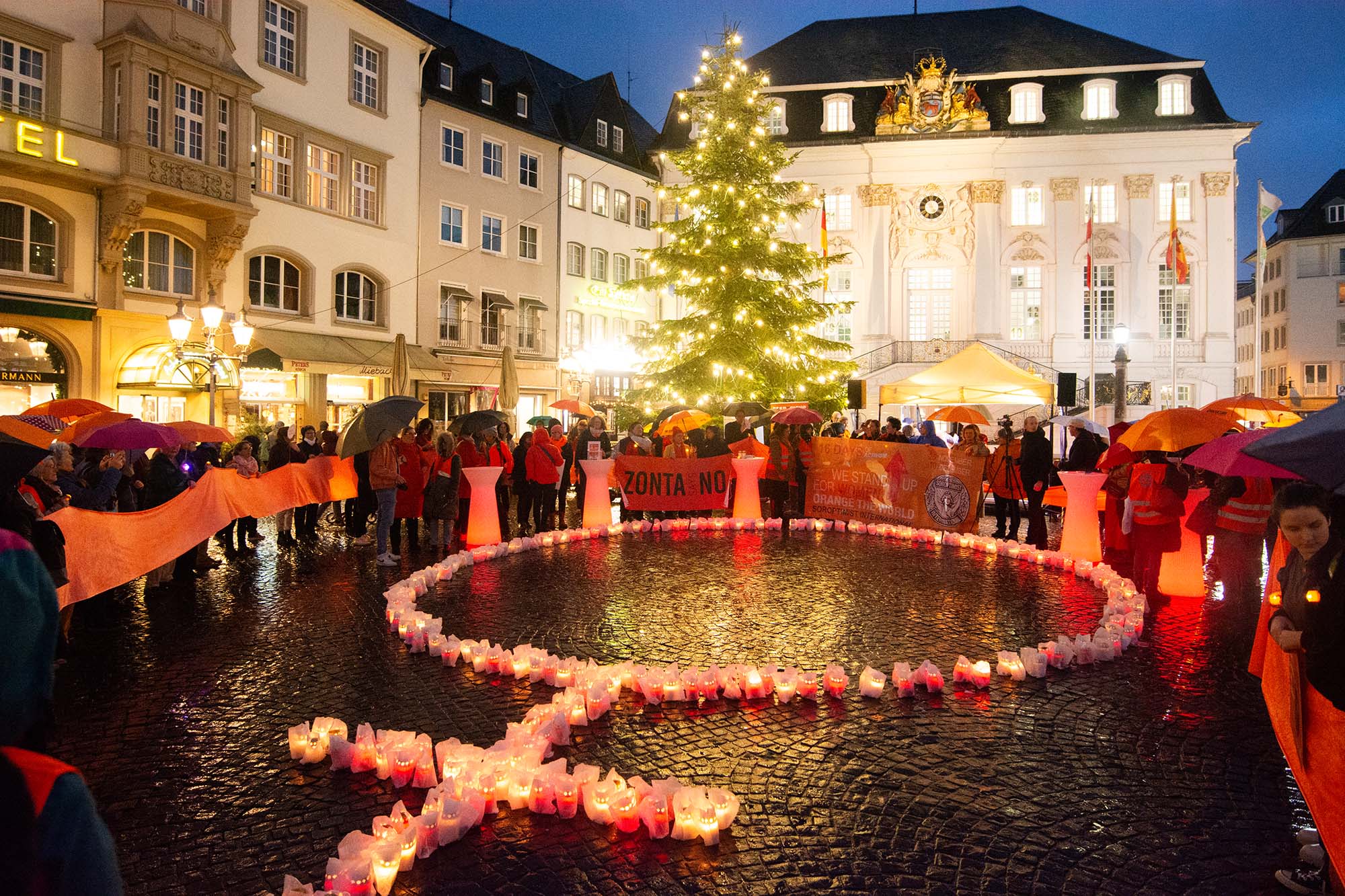 365 candles with the symbol of a woman are illuminated in front of the Townhall as hundreds of participants take part in a demonstration for International Women's Day