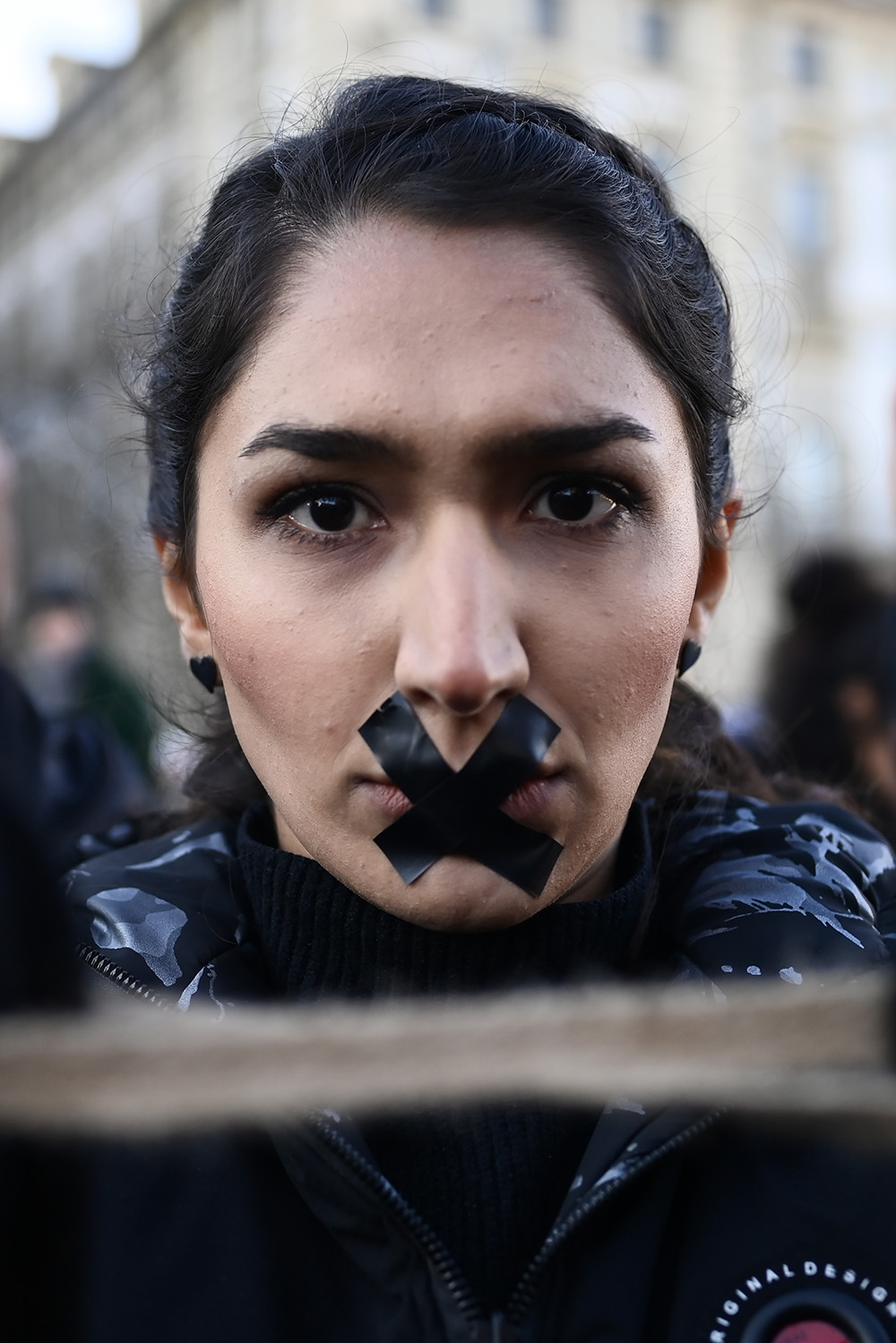 Woman with an X on their mouth during the protest in honour of the lives of Iranian Women on December 17, 2022 in Turin, Italy.