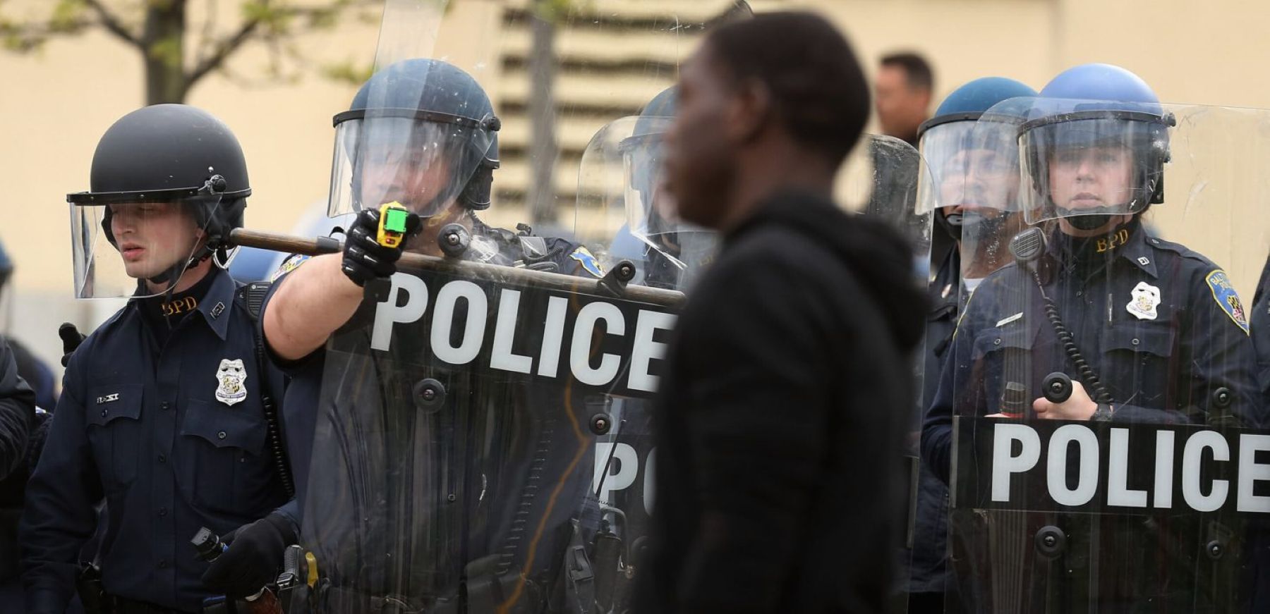 A Baltimore Police officer aims his taser at a demonstrator outside the Mondawmin Mall following the funeral of Freddie Gray April 27, 2015 in Baltimore, Maryland. Photo by Chip Somodevilla/Getty Images.
