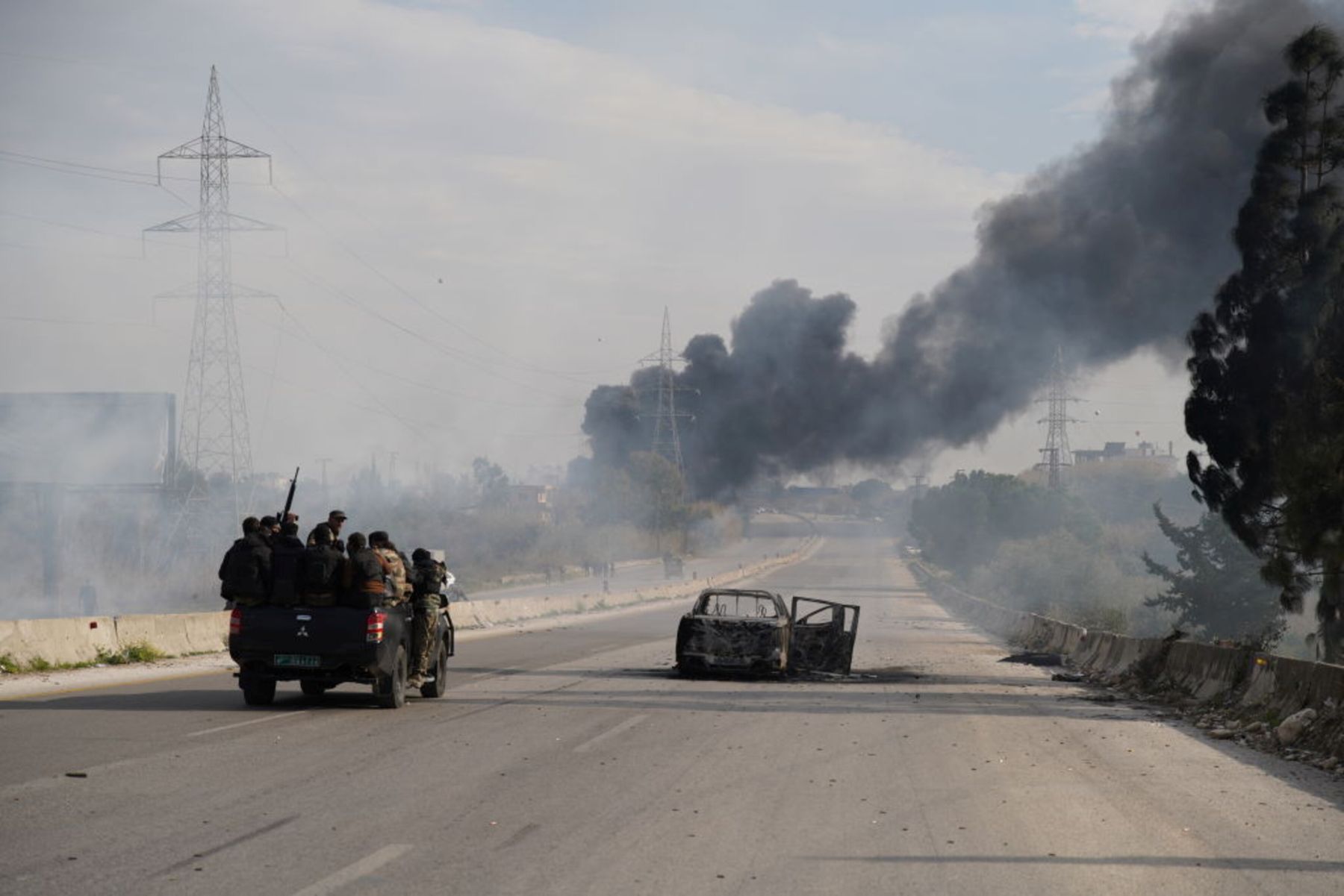 Black smoke rises as authorities extended the curfew in the cities of Latakia and Tartus in northwest Syria on Friday and launched large-scale security sweeps in urban centers, villages, and surrounding mountains to track down remnants of the deposed Bashar al-Assad regime on March 07, 2025 in Latakia, Syria. Photo by Abdulvacit Haci Isteyfi/Anadolu via Getty Images.