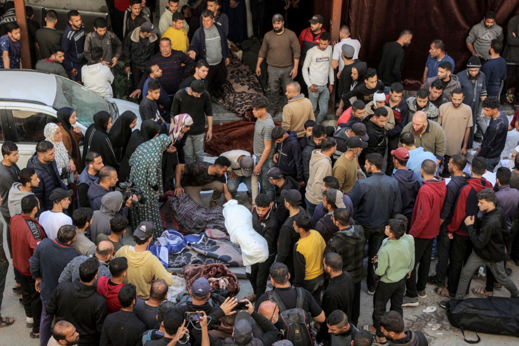 People gather in the yard of the Ahli Arab hospital, also known as the Baptist hospital, to mourn and bid farewell to the bodies of victims killed in Israeli bombardment, in Gaza City on March 18, 2025. Photo by OMAR AL-QATTAA/AFP via Getty Images.