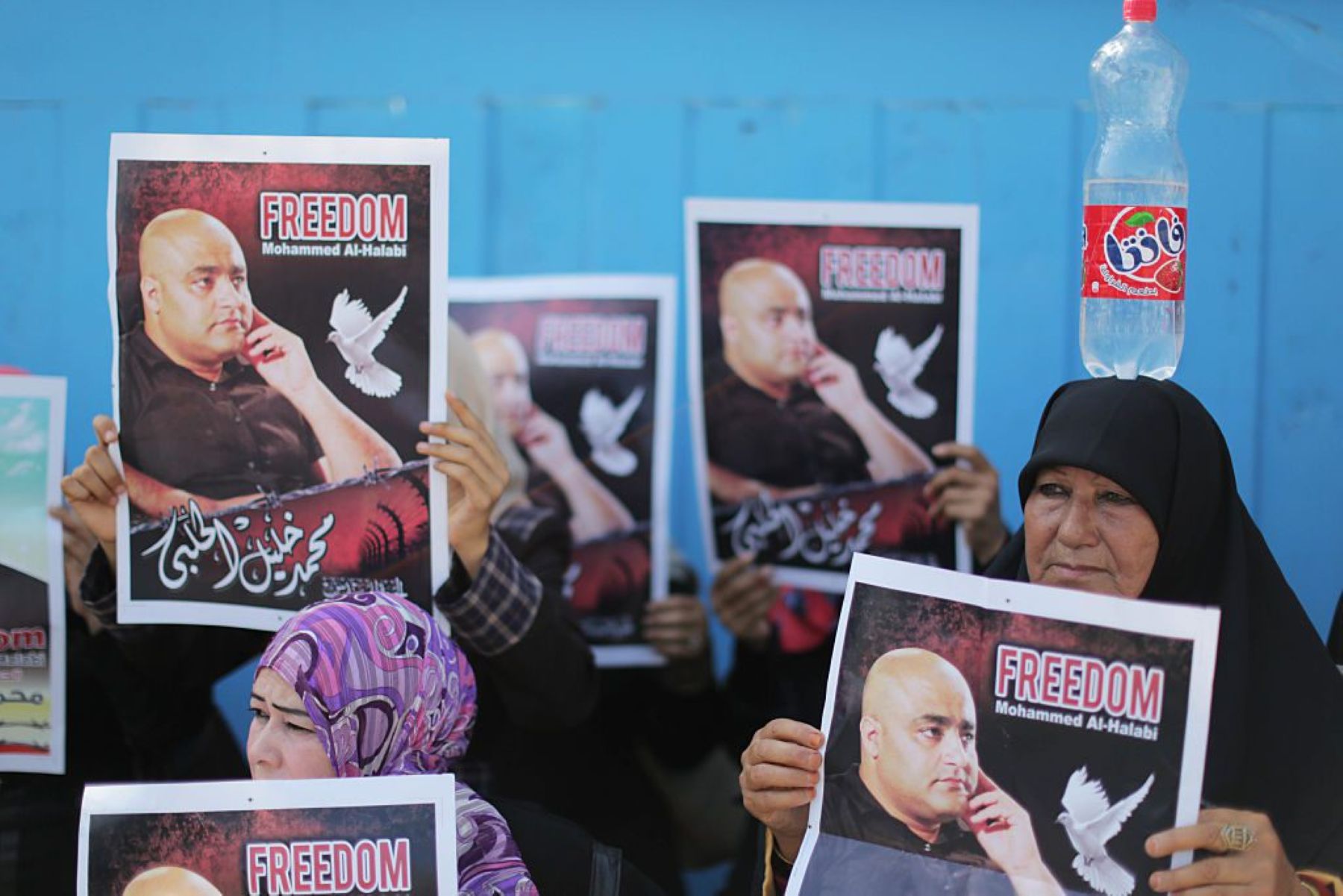 Palestinian demonstrators hold posters of Mohammad El Halabi. Photo by Momen Faiz/NurPhoto via Getty Images.