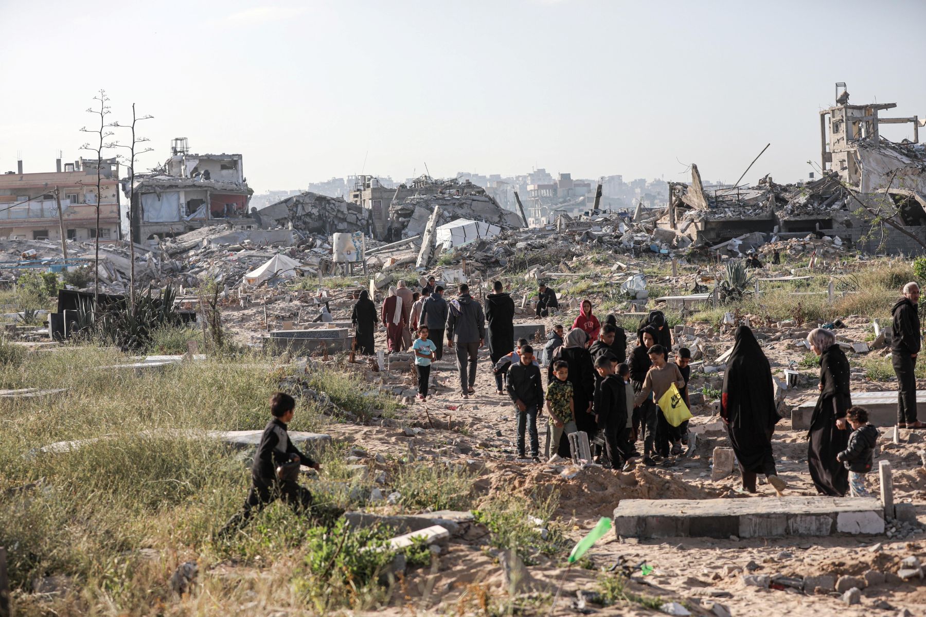 Palestinians visit the city cemetery damaged by Israeli attacks after performing the Eid al-Fitr prayer marking the end of the holy month of Ramadan in Beit Lahia, Gaza on March 30, 2025. Photo by Abdalhkem Abu Riash/Anadolu via Getty Images.