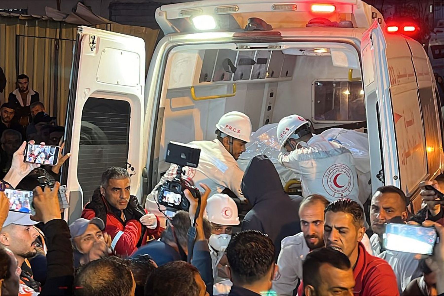Paramedics transport out of an ambulance some of the bodies of Palestinian first responders, who were killed a week before in Israeli military fire on ambulances, into Nasser Medical Complex in Khan Yunis in the southern Gaza Strip on March 30, 2025.Photo by AFP via Getty Images.