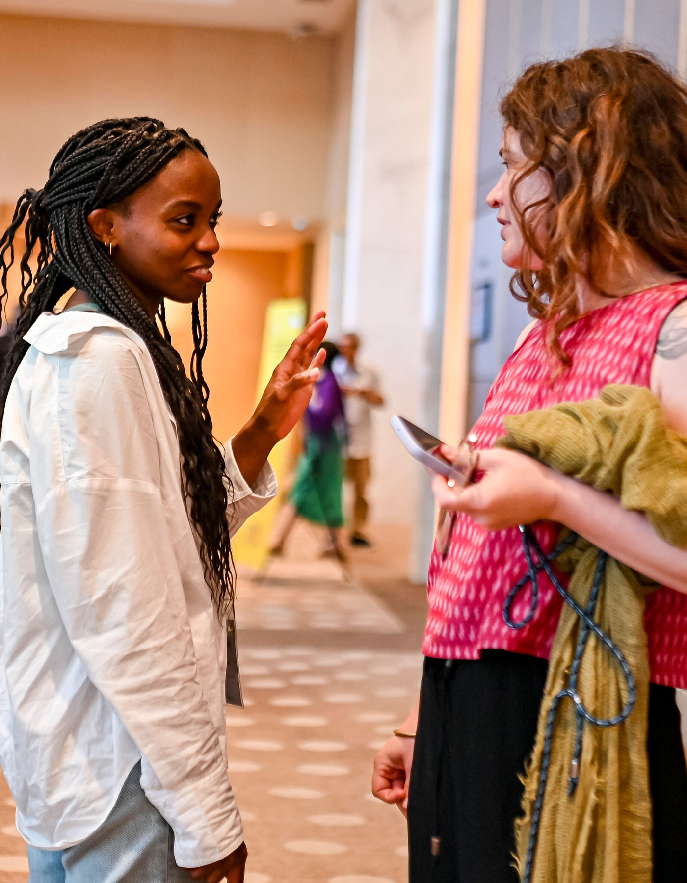 2 women having a conversation at an Amnesty event
