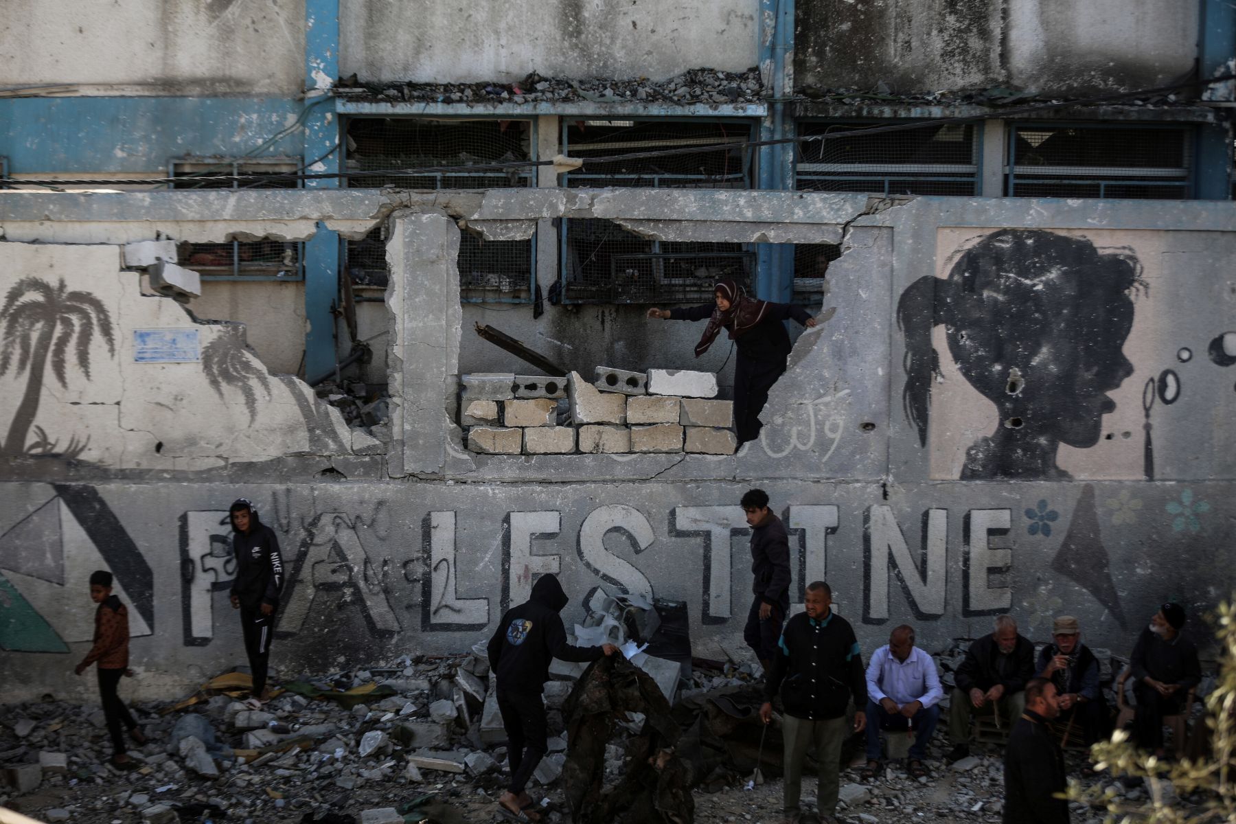 Residents of the area examine the rubble of the damaged targeted and surrounding buildings following an Israeli attack on Nuseirat Refugee Camp, in Gaza City, Gaza on May 6, 2025. Photo by Ali Jadallah/Anadolu via Getty Images.