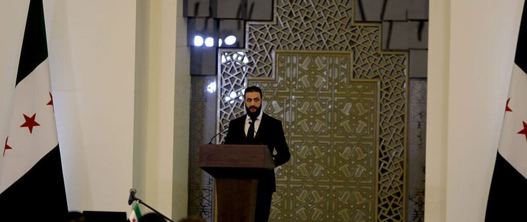 Syrian President Ahmad al-Sharaa makes a speech during the swearing-in ceremony for the first cabinet formed under the presidency of President al-Sharaa after the overthrow of the 61-year Baathist regime, held at the People's Palace in the Syrian capital Damascus on March 29, 2025. Photo by Bakr Al Kasem/Anadolu via Getty Images.