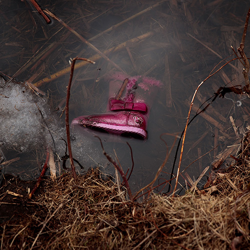 A child's boot in a pond