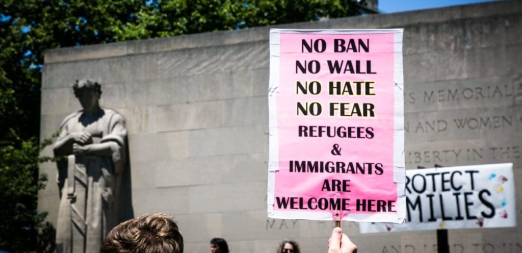 Protest sign with the words: No Ban No Wall No Hate No fear Refugees & Immigrants Are Welcome Here. © Karla Ann Cote/NurPhoto via Getty Images