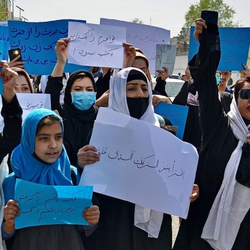 Afghan women and girls take part in a protest in front of the Ministry of Education in Kabul on March 26, 2022, demanding that high schools be reopened for girls. Photo by Photo by AHMAD SAHEL ARMAN/AFP via Getty Images.