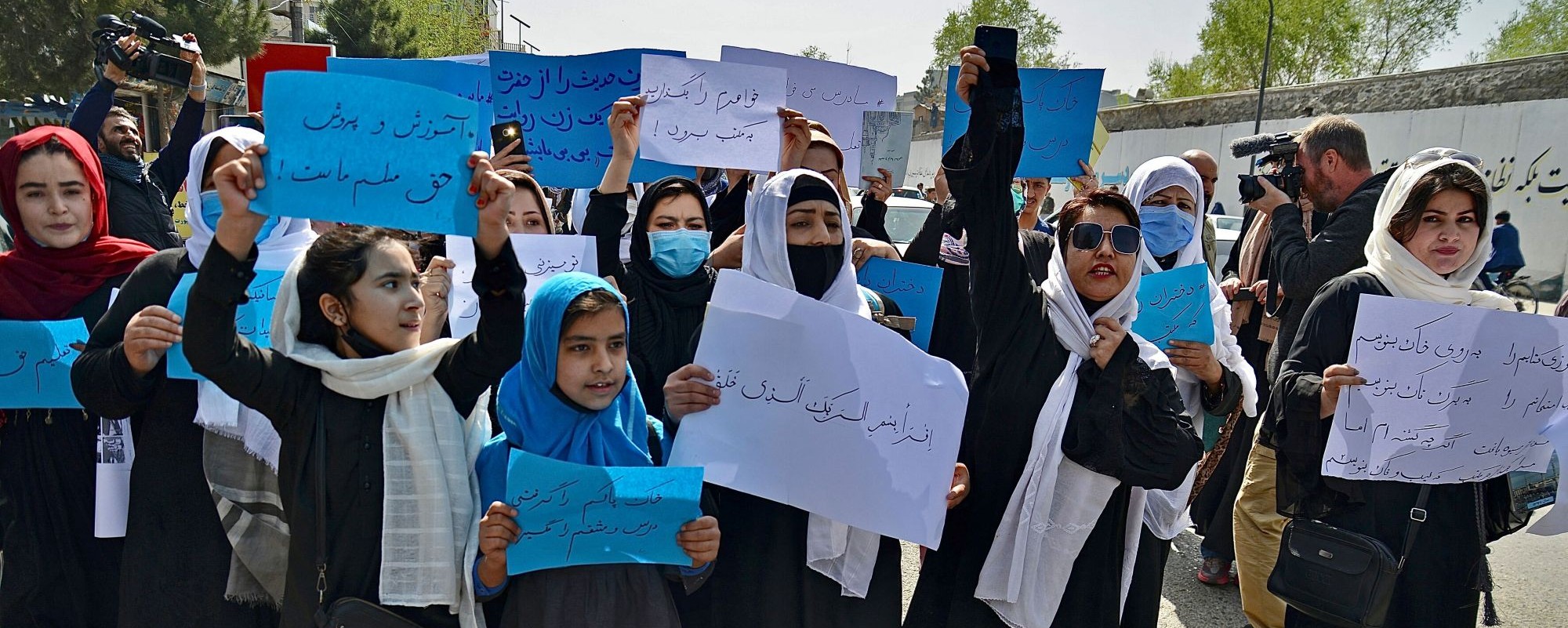 Afghan women and girls take part in a protest in front of the Ministry of Education in Kabul on March 26, 2022, demanding that high schools be reopened for girls. Photo by Photo by AHMAD SAHEL ARMAN/AFP via Getty Images.