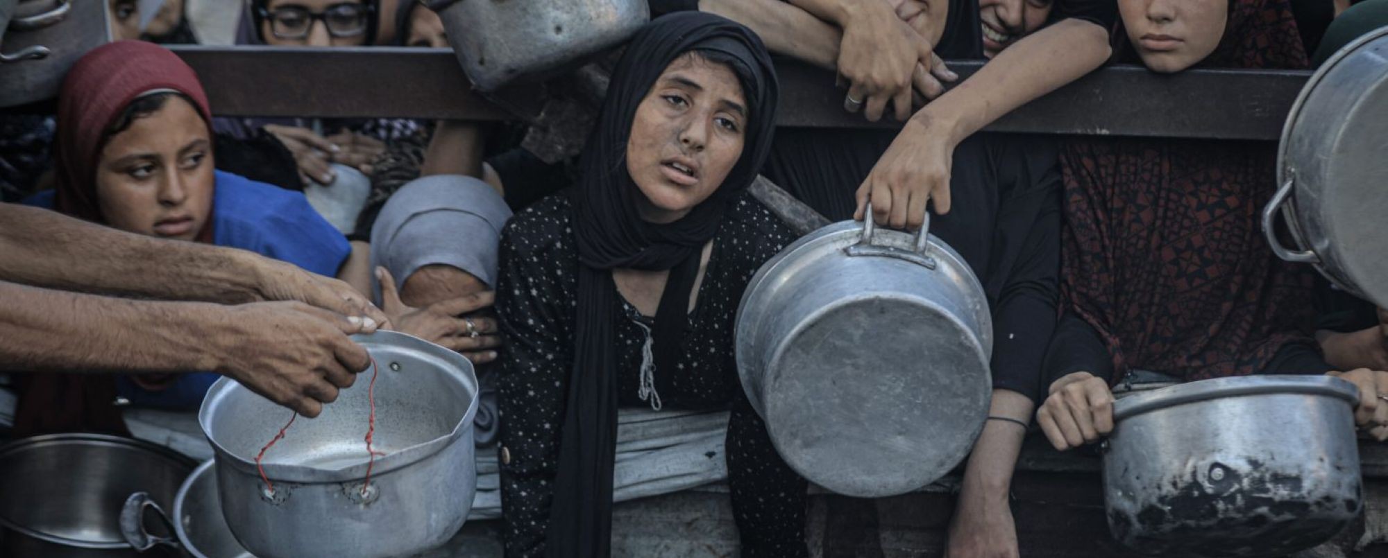Palestinians, including children, who are struggling to access food due to Israel's blockade and ongoing attacks on the Gaza Strip, wait in line to receive hot meals distributed by the charity organization in Gaza City, Gaza on July 16, 2025. Photo by Ahmed Jihad Ibrahim Al-arini/Anadolu via Getty Images.