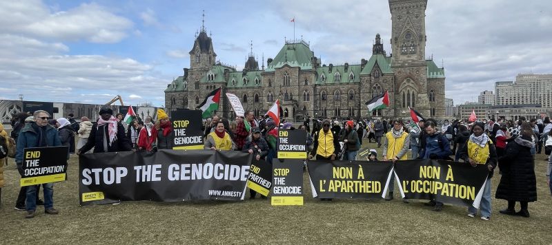 Amnesty activists join a protest on Parliament Hill 2025