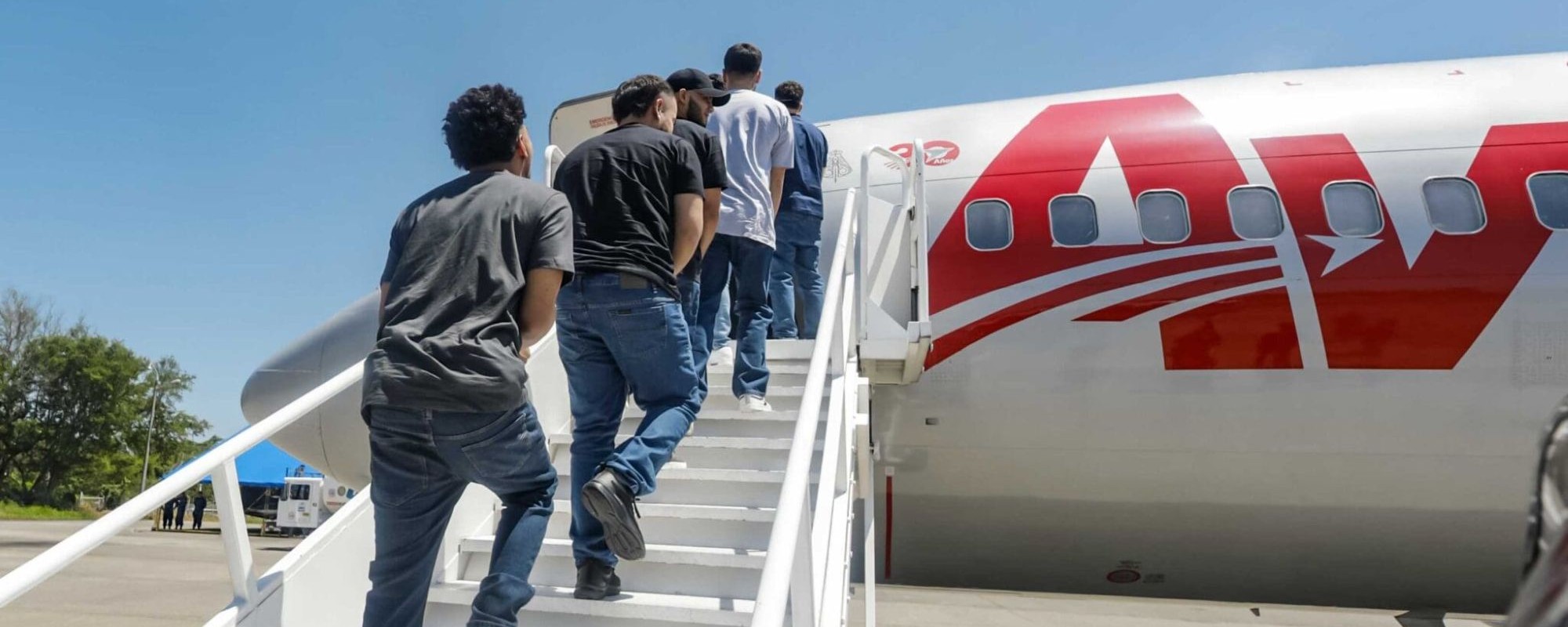 Venezuelan migrants accused by the U.S. of belonging to the Tren de Aragua criminal gang are seen being transferred from the Terrorism Confinement Center (Cecot) in El Salvador before being repatriated to Caracas on July 18, 2025 in La Paz, El Salvador. Photo by El Salvador Press Presidency Office/Anadolu via Getty Images