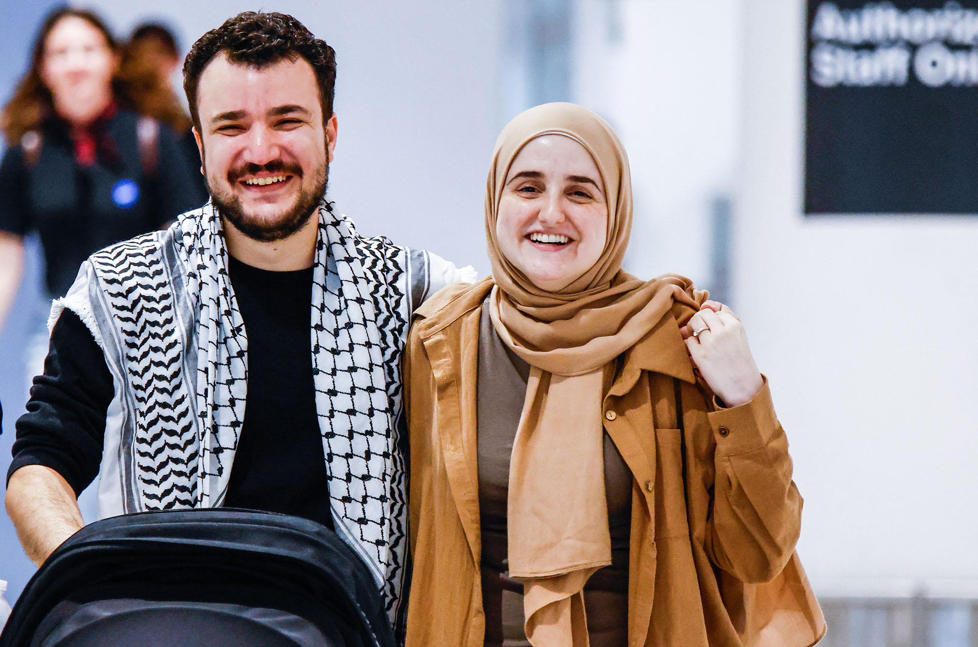 A man and women walking and smiling with relief