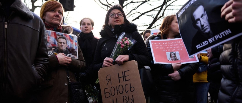People gather with photographs of the late Russian opposition leader Alexei Navalny, outside the Russian Embassy in London, on February 16, 2025, to mark the first anniversary of his death while incarcerated in a remote Arctic penal colony. Photo by BENJAMIN CREMEL/AFP via Getty images.