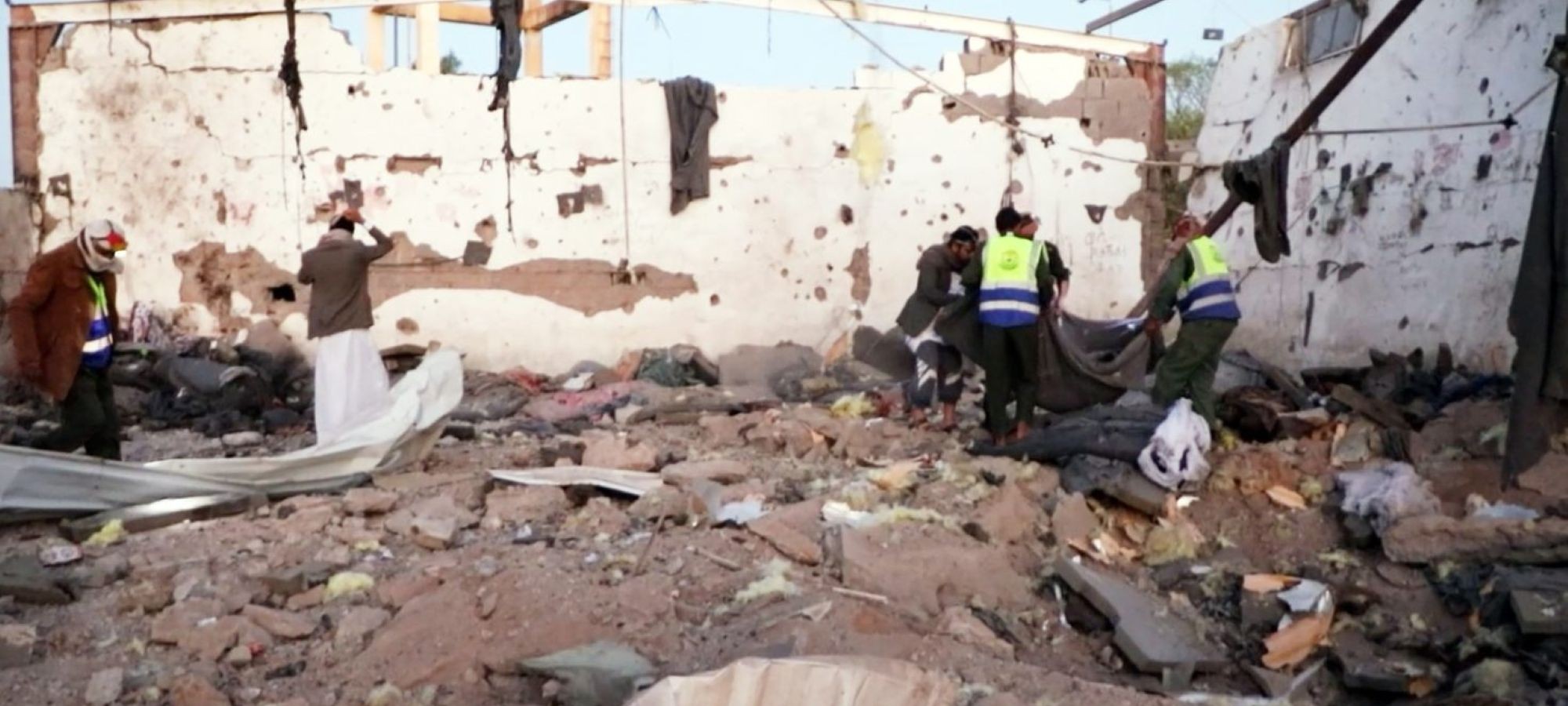 In this handout photo provided by the Houthi Media Center, Yemen's Red Cross members rescuing survivors after what the Houthis allege was a US airstrike destroyed a prison holding African migrants April 28, 2025 in Saada province, Yemen. Handout photo by Houthi Media Center/Getty Images.