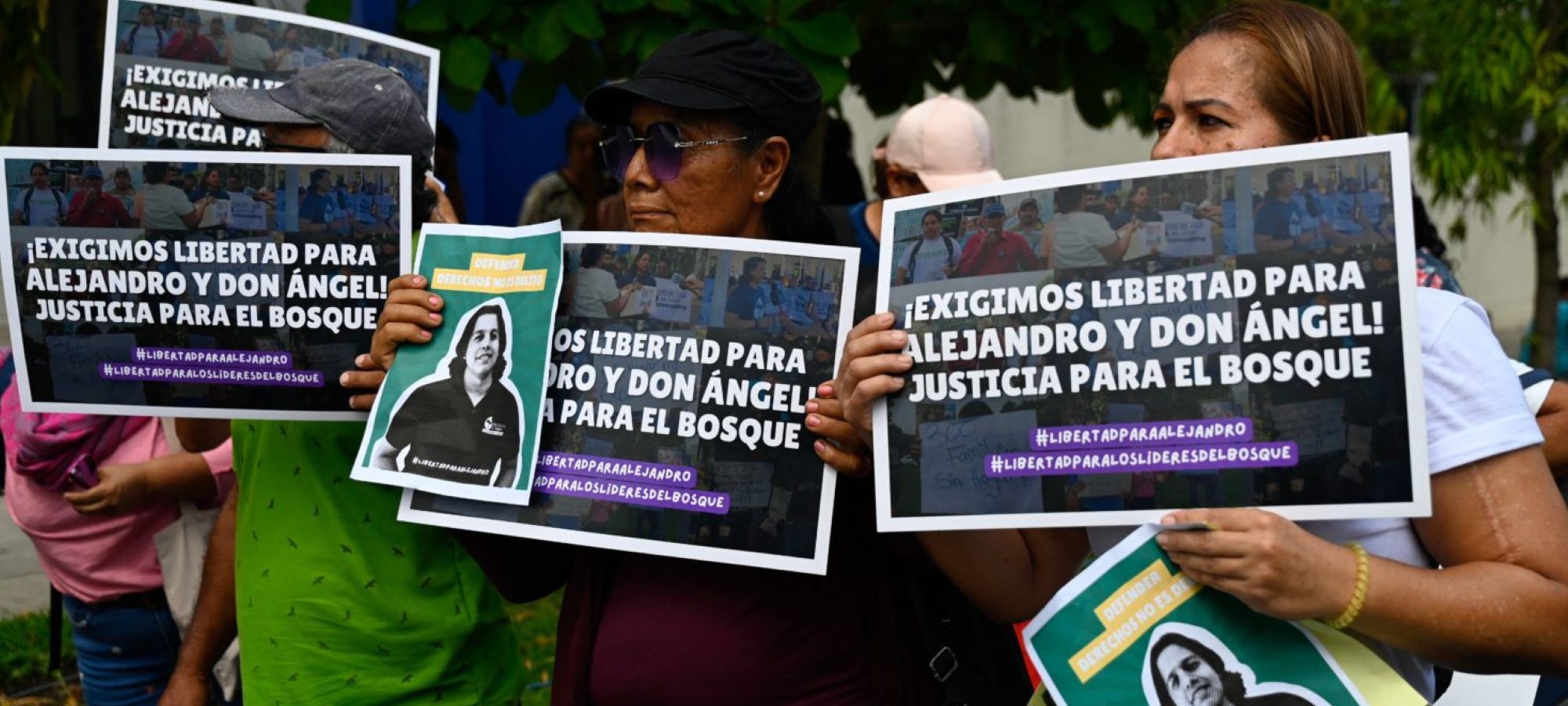 People hold signs to show their support to Salvadorean environmental lawyer activist Alejandro Henríquez and evangelical pastor Jose Angel Perez, who face charges for "aggressive resistance" and "public disorder", during the initial hearing at the Integrated Judicial Center of Santa Tecla, El Salvador on May 30, 2025. Photo by DANIELA RODRIGUEZ/AFP via Getty Images.