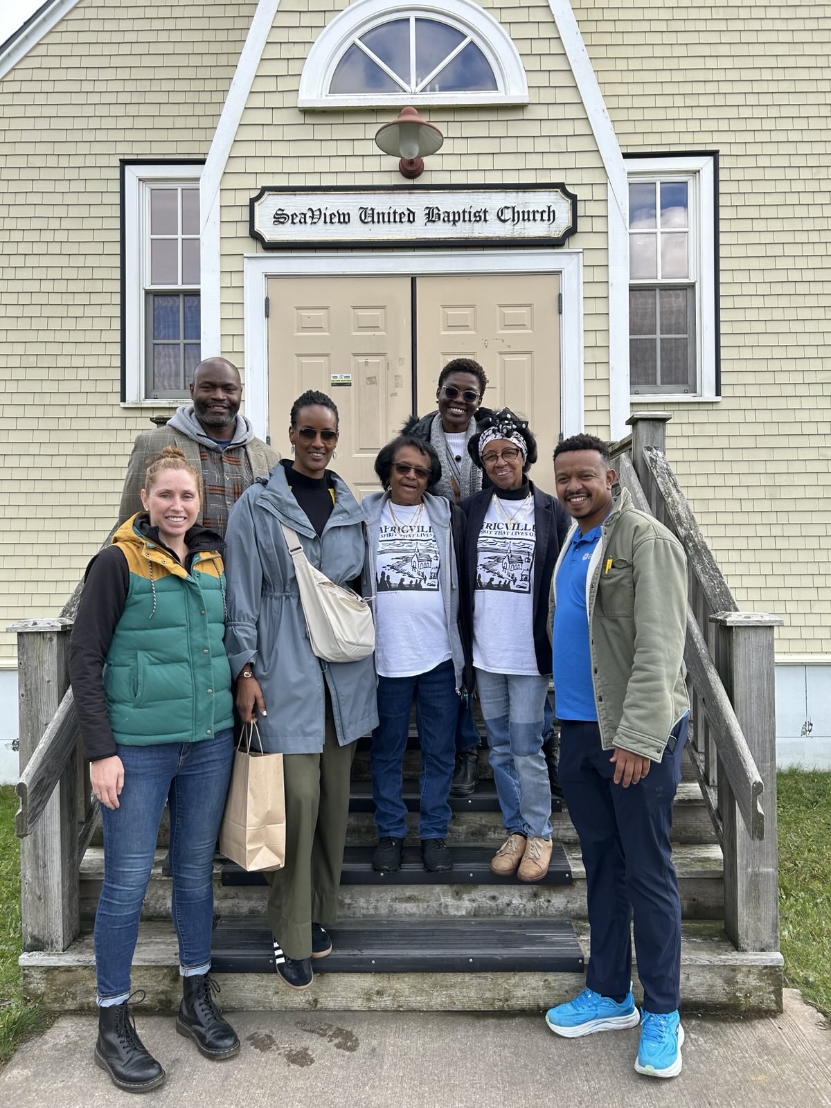 Photo: Amnesty International team with two of former Africville resident standing outside of the Africville museum  