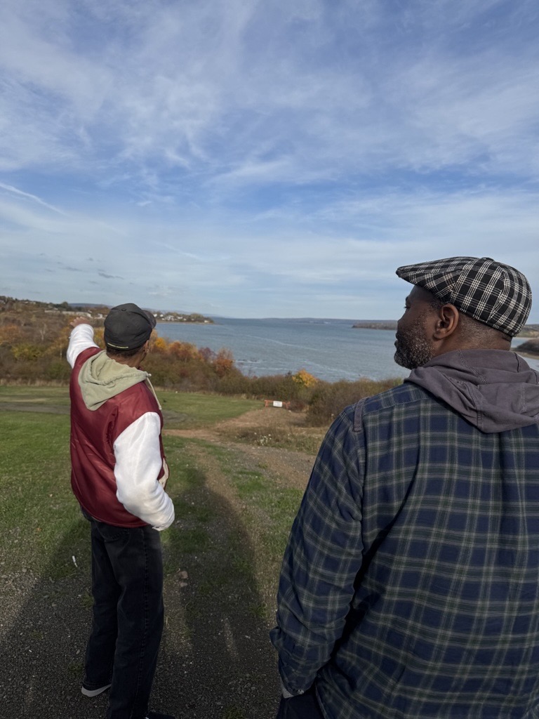 Photo: A community leader showing Amnesty International Canada’s team where the ships carrying the black loyalist first land in Nova Scotia 