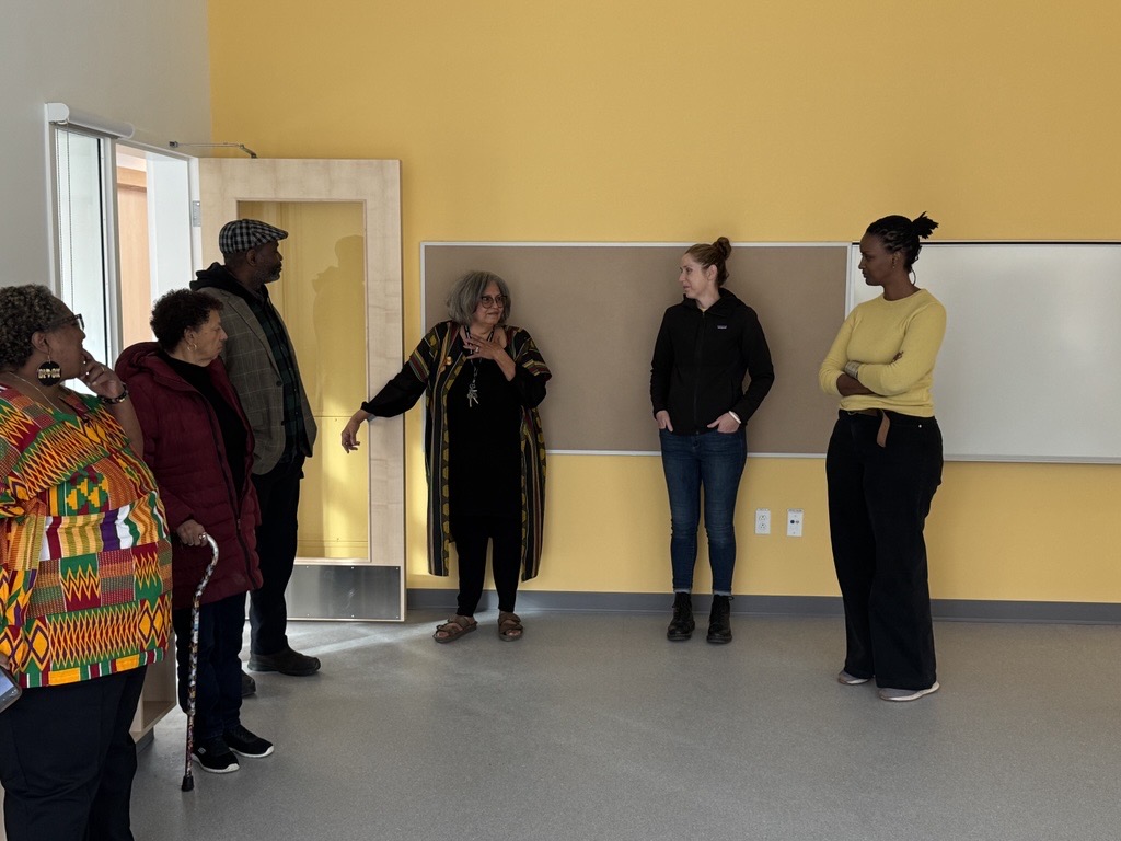 Photo: the leader of the JACBA centre providing a guided tour of the centre  